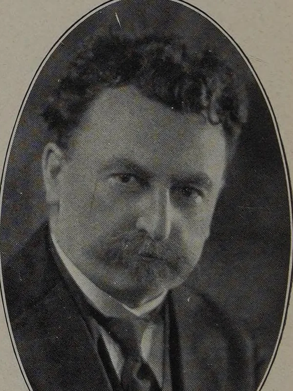 Photograph of J. Michael Reu, with moustache, in jacket and tie